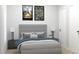 Comfortable bedroom with a gray upholstered bed, and minimalist decor at Lot 18 Blk 284 Wooley Ave, North Port, FL 34287