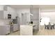 Modern kitchen features a waterfall island with seating, stainless appliances, and light gray cabinetry at Lot 18 Blk 284 Wooley Ave, North Port, FL 34287