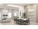 Contemporary dining area with seating for six, modern chandelier, and hardwood flooring at Lot14 Blk285 Houston Ln, North Port, FL 34287