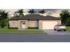 Inviting exterior showcases a manicured lawn, and a spacious two-car garage with timeless curb appeal at Lot14 Blk285 Houston Ln, North Port, FL 34287