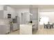 Open-concept kitchen with stainless steel appliances, white cabinets, and marble island with seating at Lot14 Blk285 Houston Ln, North Port, FL 34287