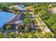 Aerial view of lush backyard featuring screened-in pool, landscaping, shed, and privacy fence at 10039 Sunday Dr, Port Charlotte, FL 33981