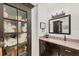 A charming bathroom featuring a granite vanity and a decorative storage cabinet at 10039 Sunday Dr, Port Charlotte, FL 33981