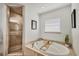 A bright bathroom with a soaking tub, tiled shower, and natural light from a window at 10039 Sunday Dr, Port Charlotte, FL 33981