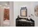Compact bathroom featuring a vanity sink, a framed mirror and a shower tub with a shower curtain at 10039 Sunday Dr, Port Charlotte, FL 33981