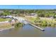 Overhead view of a community boat launch, featuring a dock extending into the lake and surrounded by lush vegetation at 10039 Sunday Dr, Port Charlotte, FL 33981