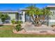 Close up of front door with stone and manicured landscaping around the walkway at 10039 Sunday Dr, Port Charlotte, FL 33981