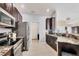 Modern kitchen featuring stainless appliances, dark wood cabinets, and granite countertops at 10039 Sunday Dr, Port Charlotte, FL 33981