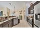 Modern kitchen featuring stainless appliances, dark wood cabinets, and granite countertops at 10039 Sunday Dr, Port Charlotte, FL 33981