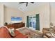 Comfortable living room with furniture and a neutral tiled floor with sliding doors to patio at 10039 Sunday Dr, Port Charlotte, FL 33981