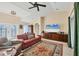 Inviting living room with neutral walls, area rug, and furniture, with views to the kitchen at 10039 Sunday Dr, Port Charlotte, FL 33981