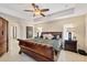The main bedroom is spacious with a tray ceiling, ceiling fan, an ensuite bath and tile floors at 10039 Sunday Dr, Port Charlotte, FL 33981