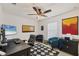 Bright office space with a ceiling fan, comfortable seating, a modern desk, and a large wall-mounted television at 10039 Sunday Dr, Port Charlotte, FL 33981