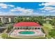Stunning aerial view of the clubhouse, showcasing a pool and manicured landscaping in the community at 10055 Links Ln # 402, Rotonda West, FL 33947