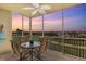 Enjoy gorgeous sunsets from this screened balcony with a ceiling fan and comfortable seating at 10055 Links Ln # 402, Rotonda West, FL 33947
