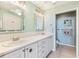 Bright bathroom featuring double sinks, white cabinetry, and modern fixtures at 10055 Links Ln # 402, Rotonda West, FL 33947