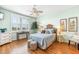 Serene bedroom with a ceiling fan, soft lighting, and hardwood flooring at 10055 Links Ln # 402, Rotonda West, FL 33947