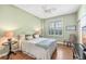 Comfortable bedroom with hardwood floors, a ceiling fan, and soft lighting at 10055 Links Ln # 402, Rotonda West, FL 33947