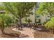 Relaxing outdoor seating area with mature trees and lush landscaping at 10055 Links Ln # 402, Rotonda West, FL 33947