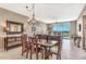 Dining room featuring a dark wood table, decorative chandelier, and tile floors at 10055 Links Ln # 402, Rotonda West, FL 33947