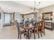 Open dining room with tile floors and views to the kitchen and entryway at 10055 Links Ln # 402, Rotonda West, FL 33947