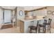 Bright kitchen with white cabinets, breakfast bar, and stylish decor at 10055 Links Ln # 402, Rotonda West, FL 33947