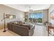 Open living room featuring a ceiling fan, slider doors to the balcony, and comfortable seating at 10055 Links Ln # 402, Rotonda West, FL 33947