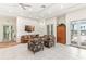 This community recreation room lounge area has comfortable seating and access to the outdoors at 10055 Links Ln # 402, Rotonda West, FL 33947