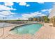 Inviting outdoor pool with a brick surround and lake views, creating a tranquil and picturesque setting at 10055 Links Ln # 402, Rotonda West, FL 33947