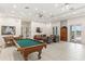 This community recreation room has a billiards table and a lounge area with comfortable seating at 10055 Links Ln # 402, Rotonda West, FL 33947