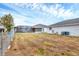 Backyard view, with screened in pool area, utility hookups and metal fencing at 10060 Amelia Ave, Englewood, FL 34224