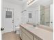 Bright bathroom features a large vanity with storage, a shower, and tile floors at 10060 Amelia Ave, Englewood, FL 34224