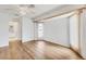 Bright bedroom featuring wood floors, a modern ceiling fan and sliding door at 10060 Amelia Ave, Englewood, FL 34224