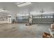 Spacious garage with multiple overhead doors, storage cabinets, and ample room for parking at 10060 Amelia Ave, Englewood, FL 34224