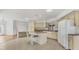 Kitchen featuring an island with bar seating, tile flooring, and ample cabinet space at 10060 Amelia Ave, Englewood, FL 34224