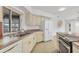 Kitchen showcasing stainless steel appliances, ample counter space, and a double sink setup at 10060 Amelia Ave, Englewood, FL 34224