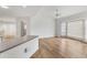 Open living room featuring hardwood floors, a ceiling fan, and a large window with natural light at 10060 Amelia Ave, Englewood, FL 34224