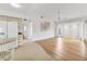 Open-concept design with hardwood floors connecting the living area to the kitchen at 10060 Amelia Ave, Englewood, FL 34224