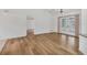 Neutral living room featuring hardwood floors, ceiling fan, and french doors at 10060 Amelia Ave, Englewood, FL 34224