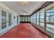 Large sun room featuring tile floors, lots of windows, and a ceiling fan at 10060 Amelia Ave, Englewood, FL 34224
