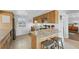 Well-lit kitchen featuring light wood cabinets, granite countertops, stainless steel appliances, and a bright window at 1010 Haste Ln, Englewood, FL 34223