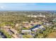 Aerial view of the community showcasing the buildings, lush greenery, pond, and surrounding area at 11 Quails Run Blvd # 9, Englewood, FL 34223