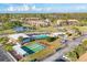 An aerial view showcases the community pool, shuffleboard courts, and well-maintained landscaping at 11 Quails Run Blvd # 9, Englewood, FL 34223