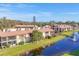 An aerial view that features the community's waterfront and well-maintained buildings at 11 Quails Run Blvd # 9, Englewood, FL 34223