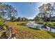 Park bench with beautiful view of fountain and meticulously kept grounds at 11 Quails Run Blvd # 9, Englewood, FL 34223