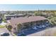 Exterior of a multi-story condo building with manicured landscaping and ample parking at 11 Quails Run Blvd # 9, Englewood, FL 34223