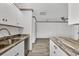 Well-lit kitchen features stainless steel appliances, custom cabinets, and stylish countertops at 11 Quails Run Blvd # 9, Englewood, FL 34223
