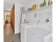 Functional laundry room featuring a washer, dryer, and storage shelving at 11 Quails Run Blvd # 9, Englewood, FL 34223