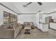 Living room with hardwood floors, seating, and a large window at 11 Quails Run Blvd # 9, Englewood, FL 34223