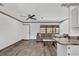 Open living area with plank floors, ceiling fan, and comfortable seating. Natural light throughout at 11 Quails Run Blvd # 9, Englewood, FL 34223